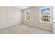 Bright bedroom with neutral carpet, white trim, and large windows that offer great natural light at 266 Hanging Elm Ln, Fuquay Varina, NC 27526