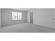 Bright bedroom with neutral walls, carpeted floors and natural light from a large window at 266 Hanging Elm Ln, Fuquay Varina, NC 27526
