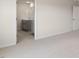 A carpeted bedroom adjoins a bathroom with double sinks and gray cabinets at 266 Hanging Elm Ln, Fuquay Varina, NC 27526