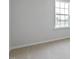 Bright bedroom featuring neutral carpet, white walls, base trim and a double-hung window at 266 Hanging Elm Ln, Fuquay Varina, NC 27526