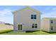 Rear exterior featuring siding, sliding glass doors, and a small concrete patio at 266 Hanging Elm Ln, Fuquay Varina, NC 27526