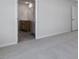 Hallway featuring neutral walls, carpeted floors and views into the bathroom at 266 Hanging Elm Ln, Fuquay Varina, NC 27526