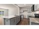 Kitchen with gray cabinets, granite countertops, stainless steel appliances and an island with a double sink at 266 Hanging Elm Ln, Fuquay Varina, NC 27526