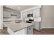 Kitchen with gray cabinets, granite countertops, stainless appliances, and a large island with sink at 266 Hanging Elm Ln, Fuquay Varina, NC 27526