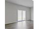 Bright living room with neutral walls, recessed lights, wood floors and sliding glass doors to the backyard at 266 Hanging Elm Ln, Fuquay Varina, NC 27526