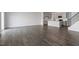 Open-concept living room featuring hard wood flooring, providing ample space for relaxation and entertainment at 266 Hanging Elm Ln, Fuquay Varina, NC 27526