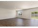 Spacious living room with wood flooring, a sliding glass door and a large window at 266 Hanging Elm Ln, Fuquay Varina, NC 27526