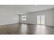 Bright living room with neutral walls, recessed lights, wood floors and sliding glass doors to the backyard at 266 Hanging Elm Ln, Fuquay Varina, NC 27526