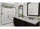 Luxurious bathroom with a walk-in shower, double vanity, and marble-like tile at 4073 Elk Creek Ln, Raleigh, NC 27612