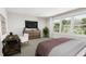 This bedroom features a desk, dresser with TV, and a large window, creating a comfortable and functional space at 4073 Elk Creek Ln, Raleigh, NC 27612