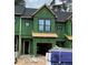 Unfinished townhome showcasing windows, garage, and Zip System sheathing, awaiting its final touches at 4073 Elk Creek Ln, Raleigh, NC 27612