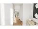 Bright hallway showcasing hardwood floors, modern artwork, and a glimpse of the open-concept living space at 4073 Elk Creek Ln, Raleigh, NC 27612