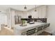Bright kitchen with white cabinetry, stainless steel appliances, and a stylish island with seating at 4073 Elk Creek Ln, Raleigh, NC 27612