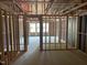 Unfinished living room showcasing the bare framework, windows, and under-construction elements at 4073 Elk Creek Ln, Raleigh, NC 27612