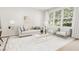 Sun-filled living room featuring neutral tones, stylish furniture, and large windows offering scenic views at 4073 Elk Creek Ln, Raleigh, NC 27612