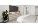 Comfortable main bedroom featuring a large dresser, sleek TV, and modern decor at 4073 Elk Creek Ln, Raleigh, NC 27612