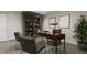 Well-appointed office features a large desk, stylish seating, built-in bookshelves, and ample natural light for a productive workspace at 4073 Elk Creek Ln, Raleigh, NC 27612