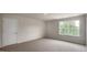 A naturally lit bedroom featuring neutral walls and carpet, and a window at 421 Citron St, Sanford, NC 27332