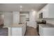 Kitchen with granite counters, stainless appliances, island with sink, and white cabinetry at 421 Citron St, Sanford, NC 27332