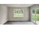 An empty room featuring hardwood flooring, a large window, and sliding glass doors leading to the outside at 421 Citron St, Sanford, NC 27332