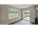 A naturally lit room features hardwood flooring, a large window, and sliding glass doors leading to the outside at 421 Citron St, Sanford, NC 27332
