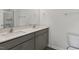 Bathroom with double sink vanity with gray cabinets, and a mirror at 425 Citron St, Sanford, NC 27332