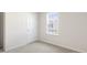 Bedroom featuring a window with a view of the neighborhood and neutral colored carpet at 425 Citron St, Sanford, NC 27332