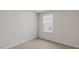 Bright bedroom featuring plush carpeting, neutral paint, and a window for natural light at 425 Citron St, Sanford, NC 27332