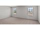 This bedroom is well lit with two windows and neutral carpet at 429 Citron St, Sanford, NC 27332