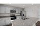 Kitchen featuring granite countertops, stainless appliances, and a large island with sink at 429 Citron St, Sanford, NC 27332