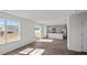 Open concept living room with luxury vinyl plank flooring, windows and sliding glass doors at 429 Citron St, Sanford, NC 27332