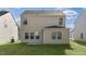 Expansive backyard featuring a newly constructed home with a walk-out concrete patio at 433 Citron St, Sanford, NC 27332