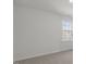 Bright room featuring neutral carpet, single window, and minimalist design at 433 Citron St, Sanford, NC 27332