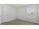 Light filled bedroom featuring a single window and neutral carpet at 433 Citron St, Sanford, NC 27332