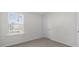 Minimalist design and neutral carpet in this well-lit bedroom with a single window at 433 Citron St, Sanford, NC 27332