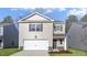 Charming two-story home features a one-car garage, neutral siding, and manicured landscaping at 433 Citron St, Sanford, NC 27332
