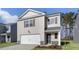 Charming two-story home features a one-car garage, neutral siding, and manicured landscaping at 433 Citron St, Sanford, NC 27332