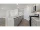 Modern kitchen featuring stainless appliances, gray cabinets, stone countertops, and a large island at 433 Citron St, Sanford, NC 27332