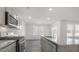 Modern kitchen features stainless appliances, gray cabinets, stone countertops, and a view of the backyard at 433 Citron St, Sanford, NC 27332
