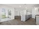 Open-concept living room and kitchen with sliding glass doors and wood-look flooring throughout at 433 Citron St, Sanford, NC 27332