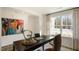 Office boasts a large window, desk, chair, decor, and rug at 437 Citron St, Sanford, NC 27332