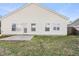 Backyard view of the home featuring a patio, lawn and vinyl siding at 4913 Sugargrove Ct, Apex, NC 27539