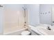 This bright bathroom features a tub with shower and vanity with sink at 4913 Sugargrove Ct, Apex, NC 27539