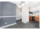 View of the dining room with gray accent wall, modern lighting, and open access to kitchen at 4913 Sugargrove Ct, Apex, NC 27539