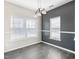 This dining room features modern gray floors and bright natural light from two large windows at 4913 Sugargrove Ct, Apex, NC 27539