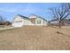 Angle view of home with front lawn, two-car garage and a green front door at 4913 Sugargrove Ct, Apex, NC 27539