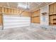 A spacious, unfinished garage with white door and cement floor at 4913 Sugargrove Ct, Apex, NC 27539