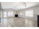 A sunlit living room features wood floors, a fireplace, and views to the exterior at 4913 Sugargrove Ct, Apex, NC 27539