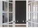 French doors opening to a room with hardwood floors and a black accent wall at 4913 Sugargrove Ct, Apex, NC 27539