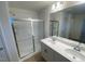 Modern bathroom featuring a glass-enclosed shower and double sink vanity with ample lighting at 544 John Stark Dr, Fuquay Varina, NC 27526